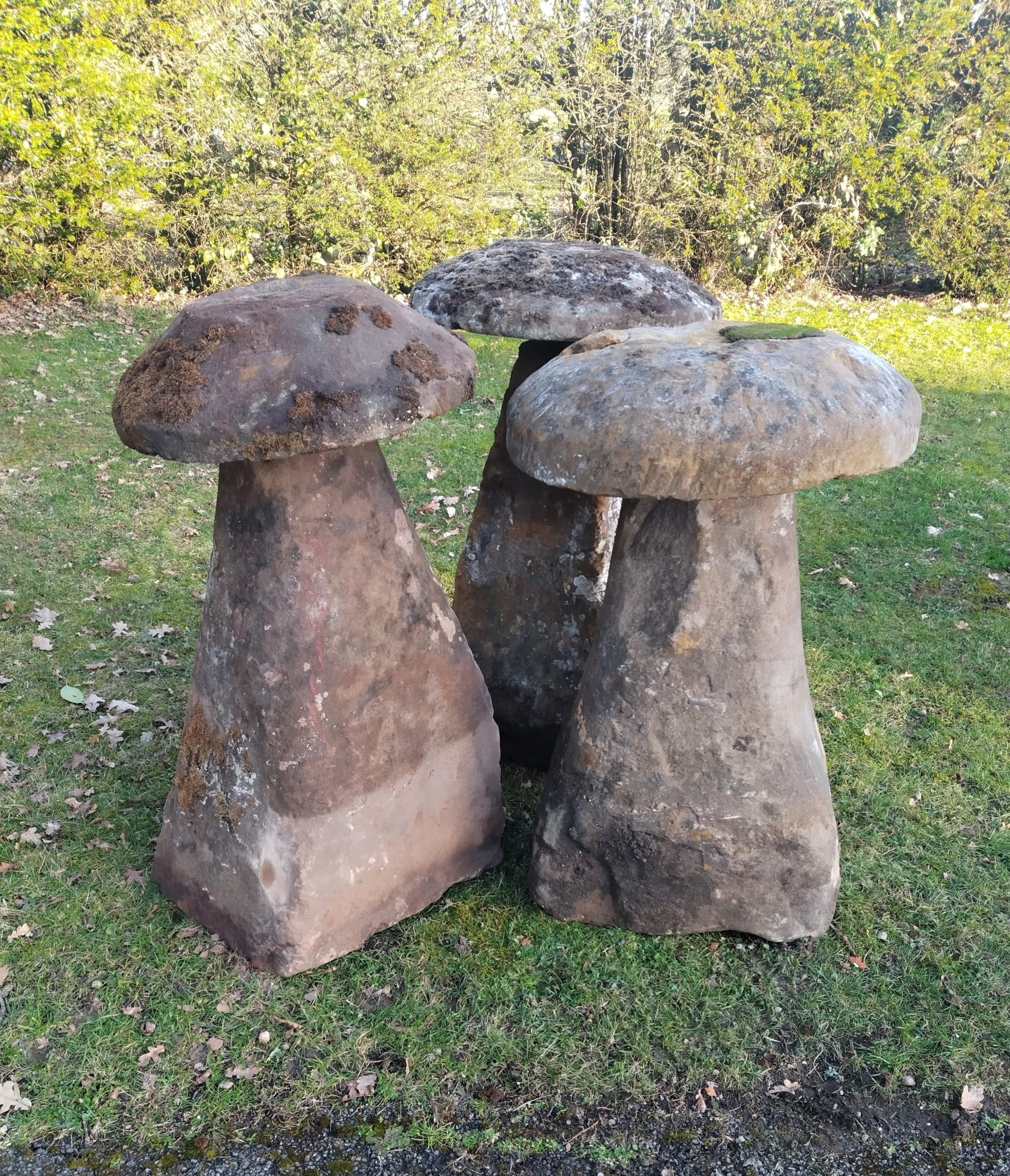 A harlequin set of three substantial carved sandstone staddle stones