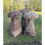 A harlequin set of three substantial carved sandstone staddle stones