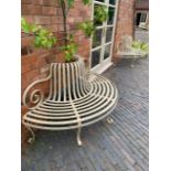 A pair of demi lune wrought iron strapwork seats