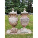 A pair of Swedish style composition stone lidded urns