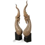 A pair of carved teakwood nagas