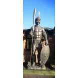 A similar impressive and colossal patinated fibreglass figure of a Zulu warrior