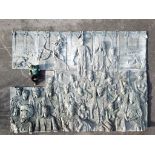 A massive and impressive patinated fibreglass plaque decorated in relief with tribal figures