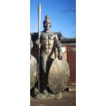 A similar impressive and colossal patinated fibreglass figure of a Zulu warrior