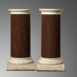 A pair of red granite column pedestals