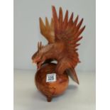 Carved figurine of Eagle on a globe