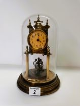 Brass glass dome skeleton clock with key