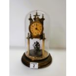 Brass glass dome skeleton clock with key