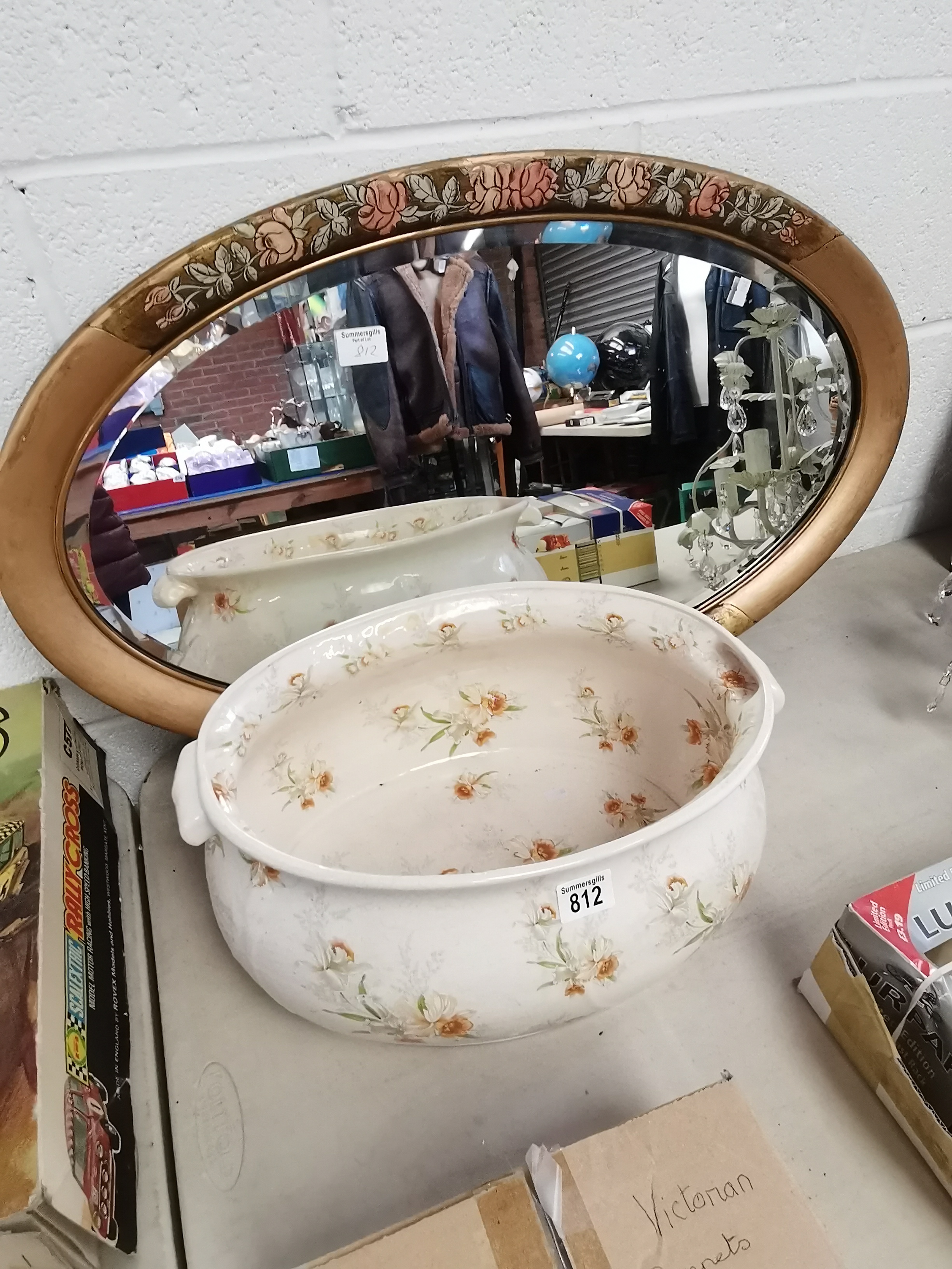 Ornate oval mirror and ironware foot bath