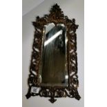 Small mirror with ornate frame