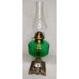 Green glass oil lamp with metal base - good condition