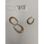 A pair of gold hooped earrings plus one