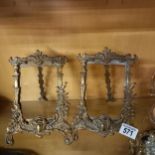 A pair of ornate brass photo frames