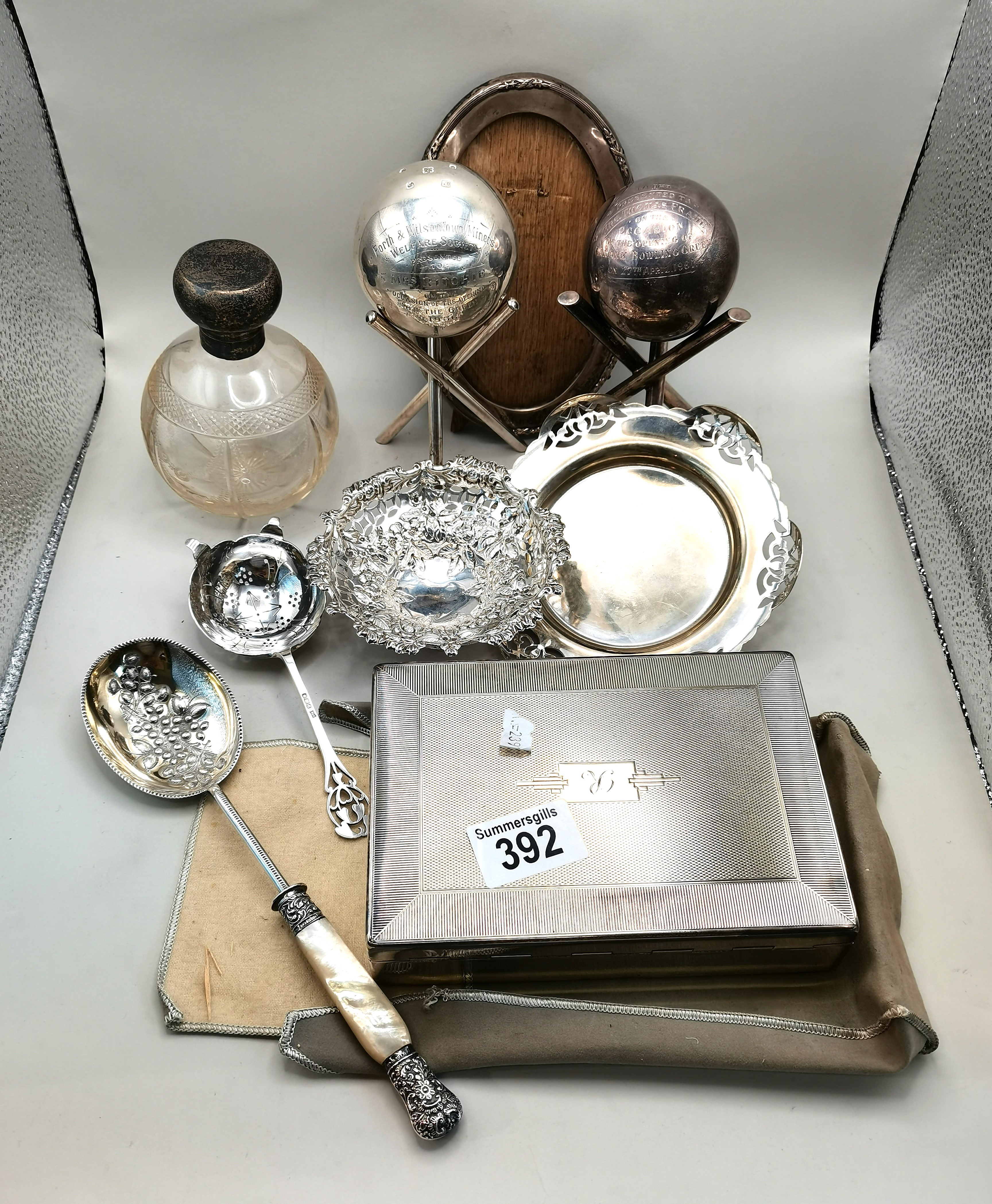 A collection of Silver and plated items including scent bottle, paperweights