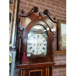 An 8 day long case clock in mahogany with stringin