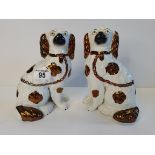 A pair of rare Staffordshire dogs with separated paws