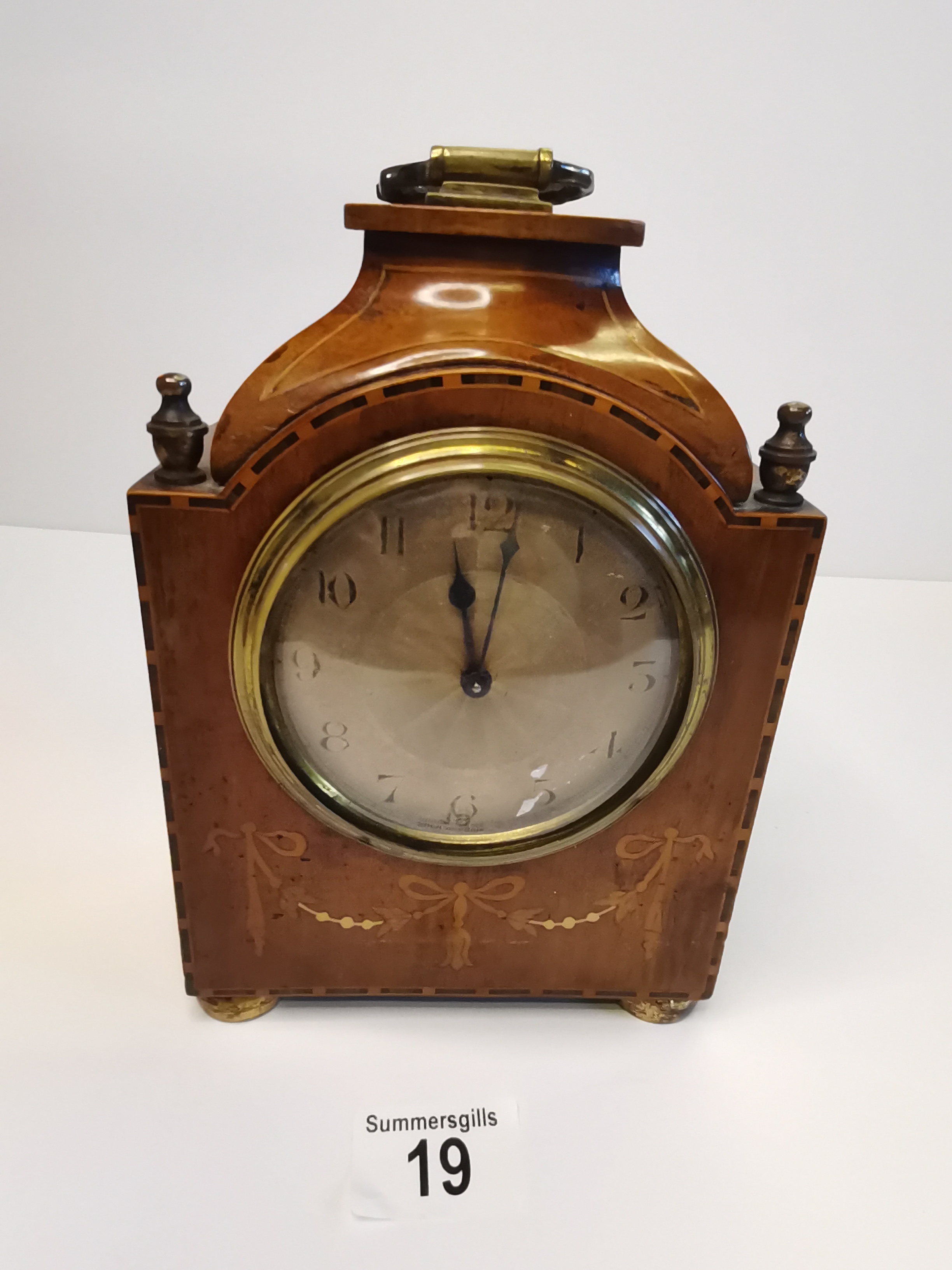 A quality Antique Inlaid Mahogany Mantle Clock with Key and Ribbon decoration