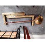 A collection of brass bed pans and fire curbs