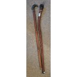 x2 Walking sticks one with a bird head and other with a clenched fist