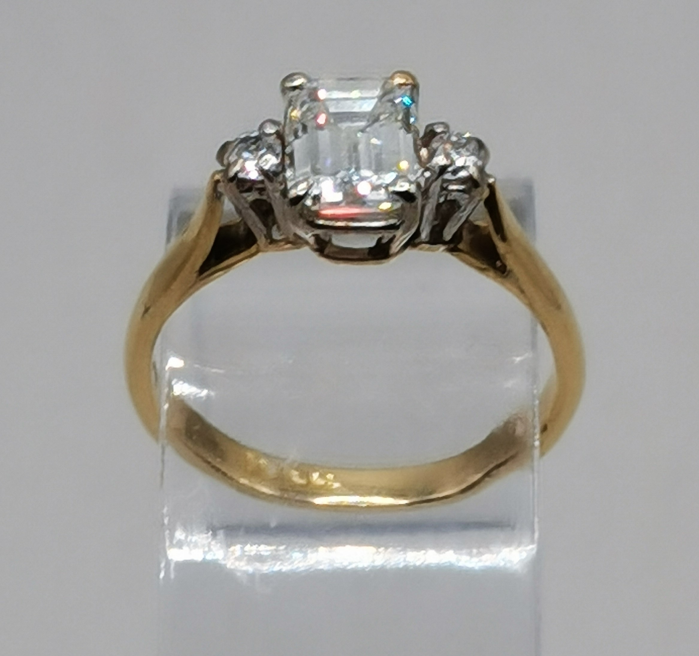 Diamond Ring - Emerald Cut 1.03 with 10 points either side in 18carat yellow gold size J