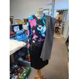 A Jaegar Floral Blouse with A Versace Black Leather Skirt and Grey Trousers