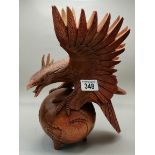 Carved figurine of Eagle on a globe