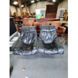 A Pair of vintage black leather Scandanavian style swivel armchairs