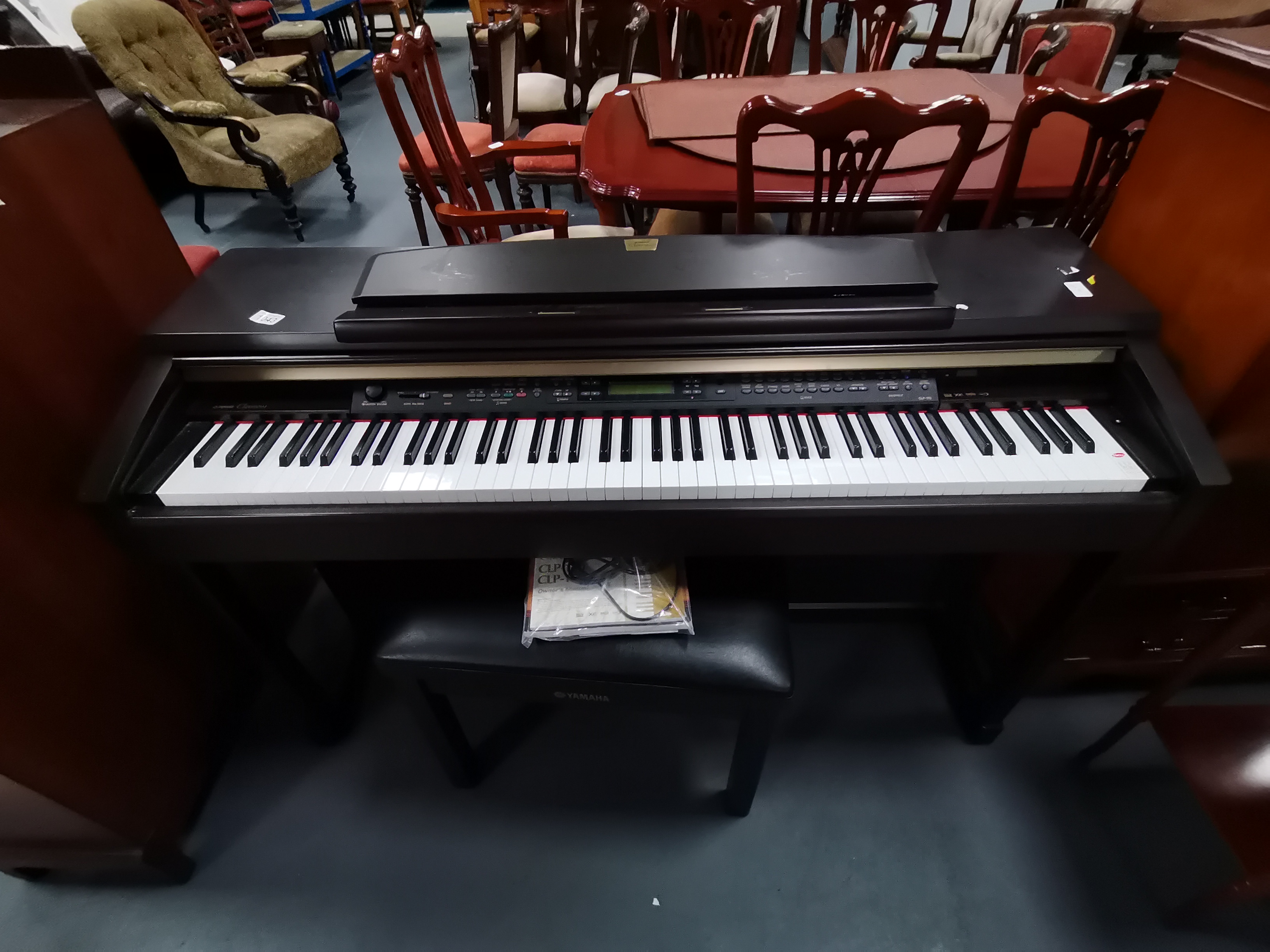 Yamaha Clavinova CLP 150 with owners manual and stool