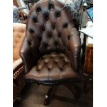Brown leather swivel office chair