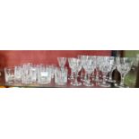 A collection of heavy cut glass wines and whisky glasses