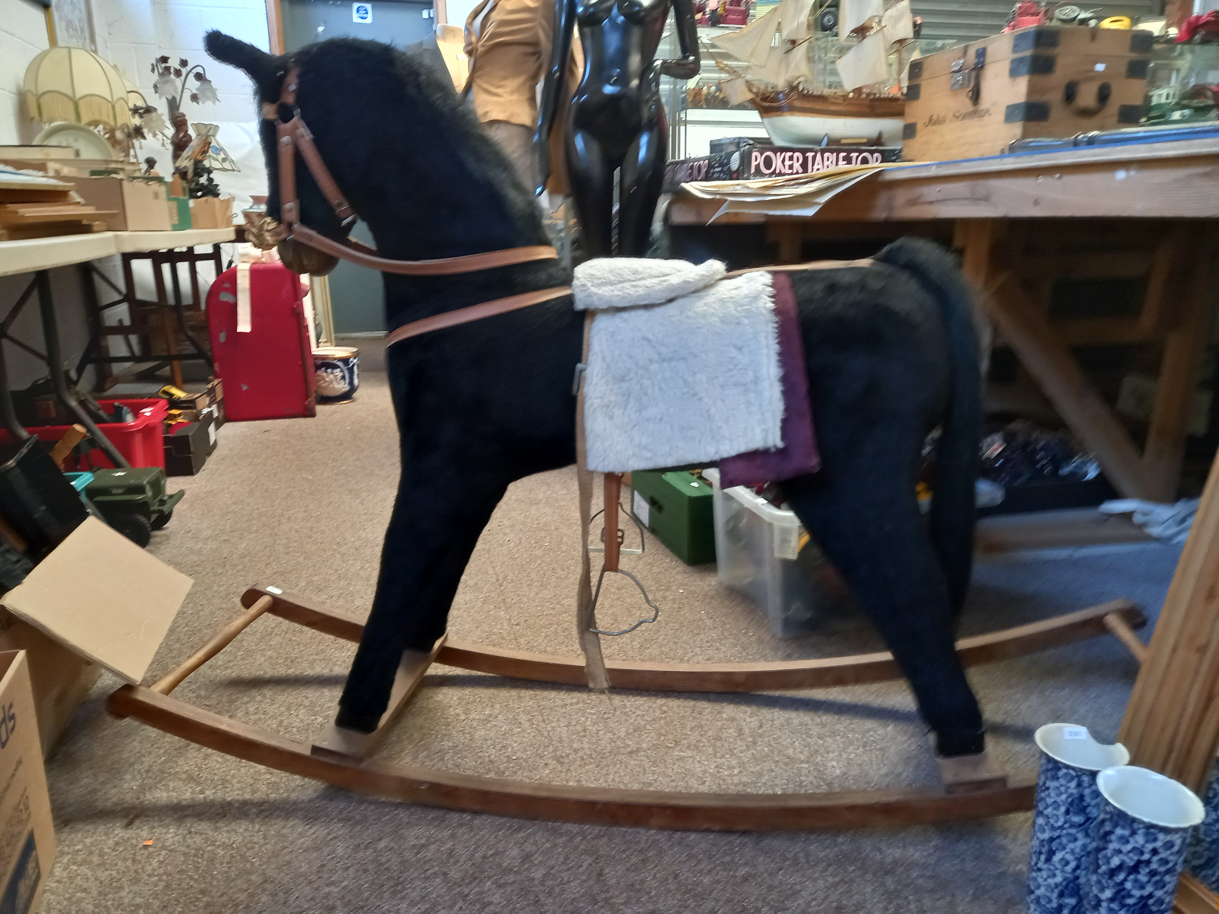 A Large Brown Rocking Horse with Saddle