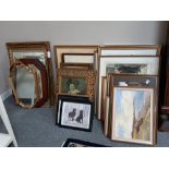 A large collection of framed pictures and mirrors