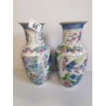 Pair of cream, blue and pink vases with bird design