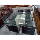 Square Travertine based glss topped dining table with 6 black and chrome chairs