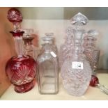 A collection of cut Glass Decanters including one Cranberry Glass