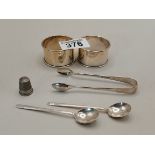 Silver items including napkin rings, sugar tongs and spoons