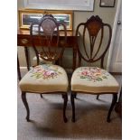 A pair of Edwardian inlaid hall chairs