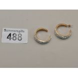 A Pair of Diamond hoop earrings set in 9ct Gold
