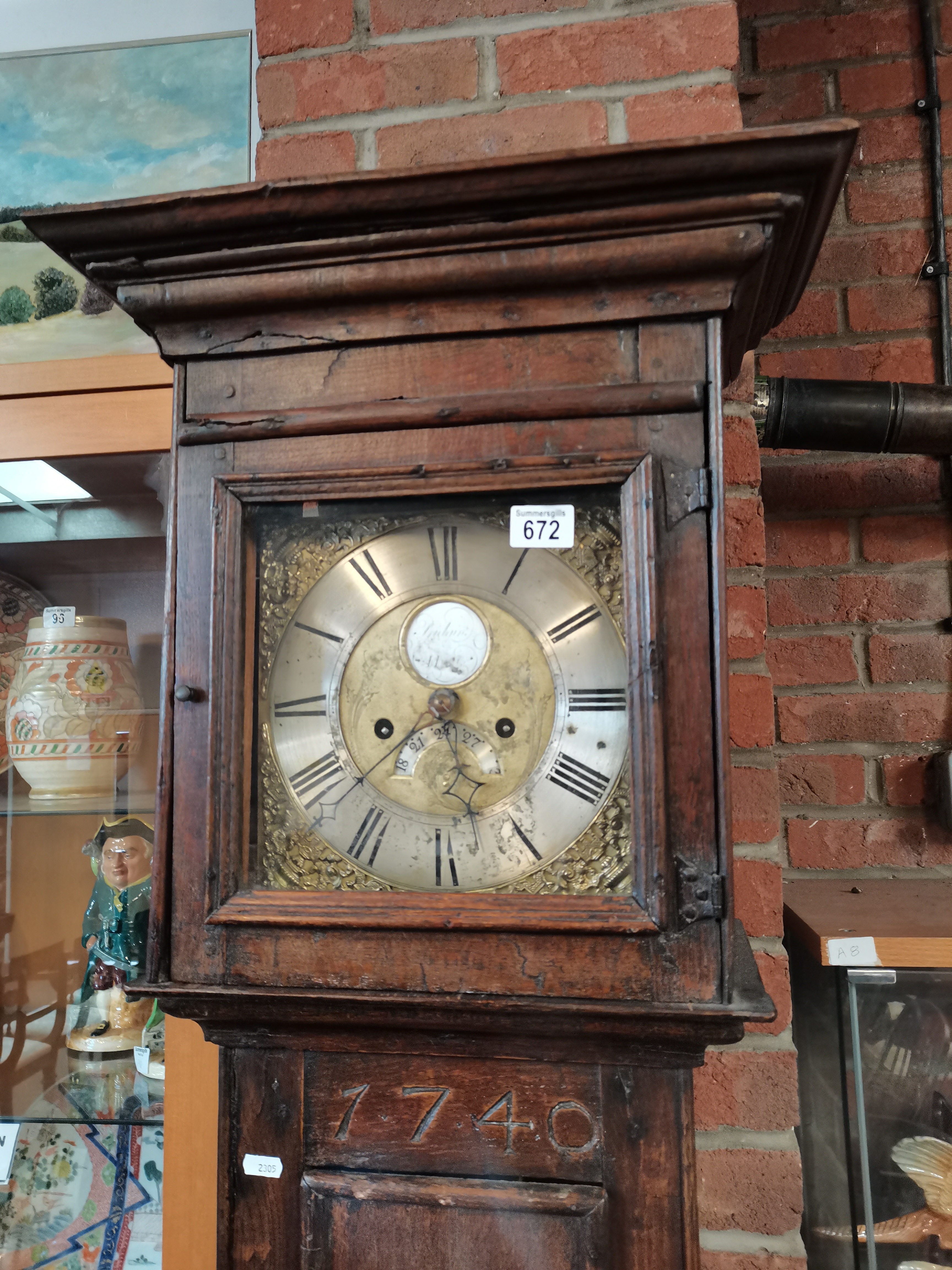 An early oak grand father clock by William Pridgin of Hull marked 1740 and having a glass bulls eye