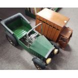 Vintage green pedal car and wooden toy truck