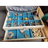 A collection of costume jewellery including beads and brooches