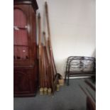 Collection of antique wooden curtain poles, vintage tins and fireguard