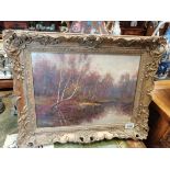 An Arthur H Ring oil on canvas of a forest and river scene 30cm x 40cm