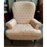 A Victorian style Cream Armchair on Casters with small pink flower pattern