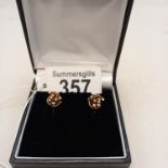 Diamond and gold earrings in a floral style decoration