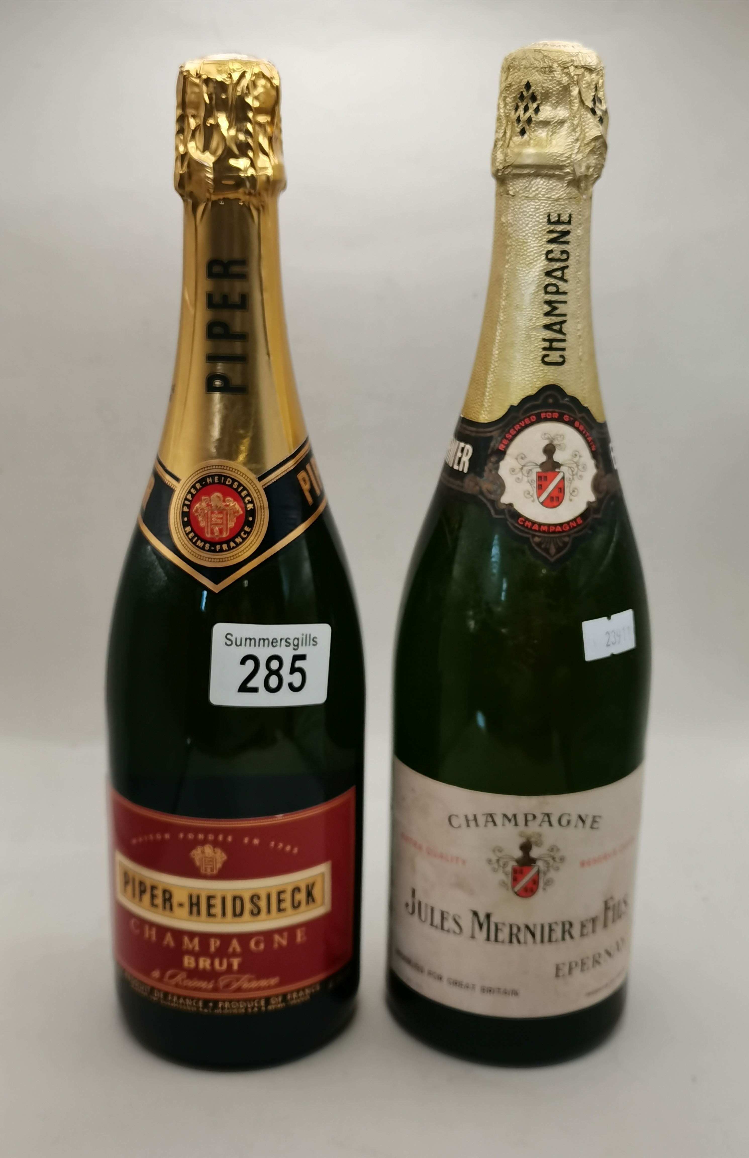 Bottle of Jules Mernier et Fils Champagne plus bottle of Piper-Heidsieck Champagne