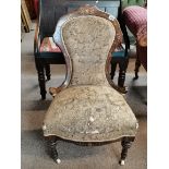 A Victorian rosewood and inlaid decoration nursing chair