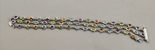 A hallmarked sterling silver and multi gem-set bracelet