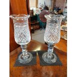 A pair of cut glass candle holders 35cm high