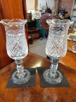 A pair of cut glass candle holders 35cm high